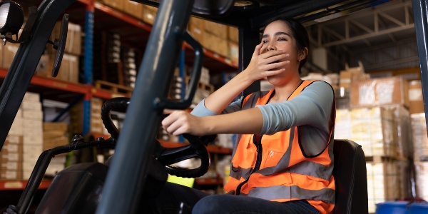 Fatigued forklift driver in a warehouse